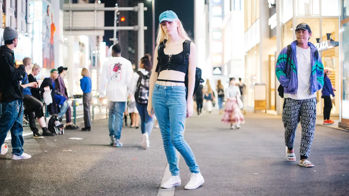 casual street styling combining creative high top shoes with dark denim outerwear
