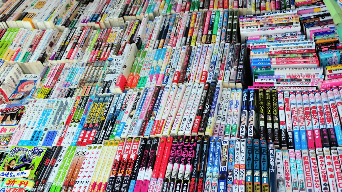 Rows of Numbered Manga Tankobon Spines for Sale how many chapters in a manga volume shown by rows of numbered tankobon spines stacked on a sales table