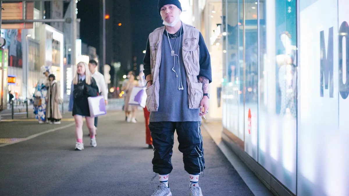 urban streetwear fashion enthusiast wearing low top sneakers paired with relaxed wide leg trousers